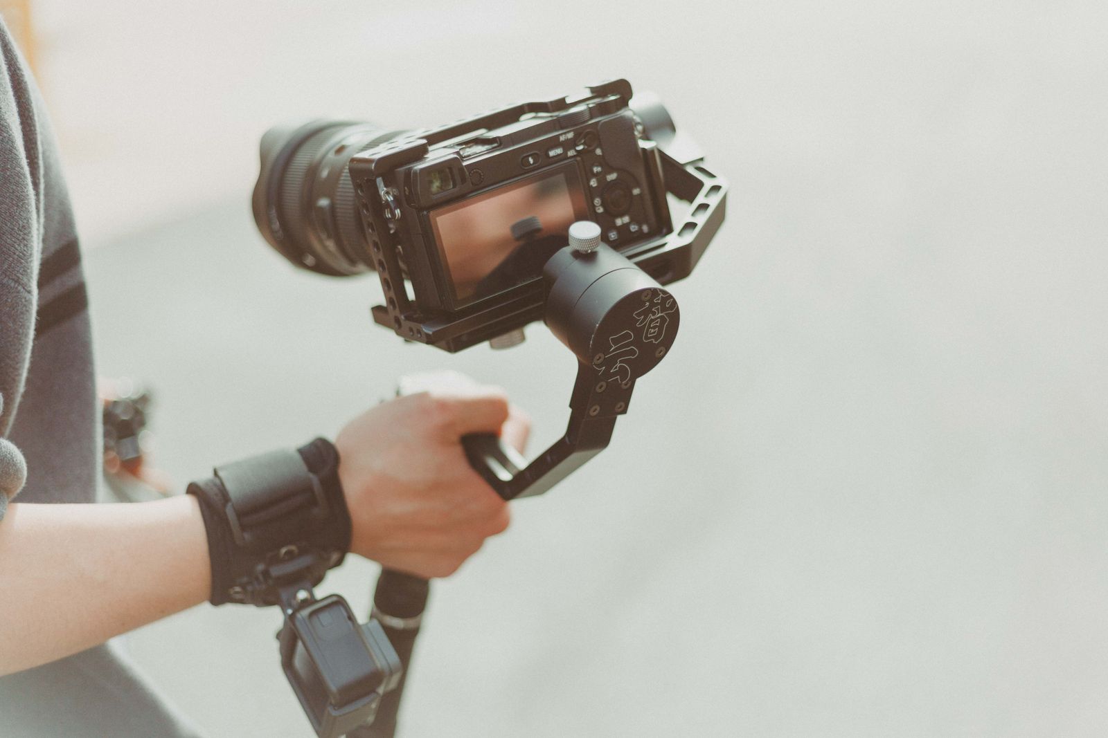 Videographer filming outdoors with a stabilized camera
