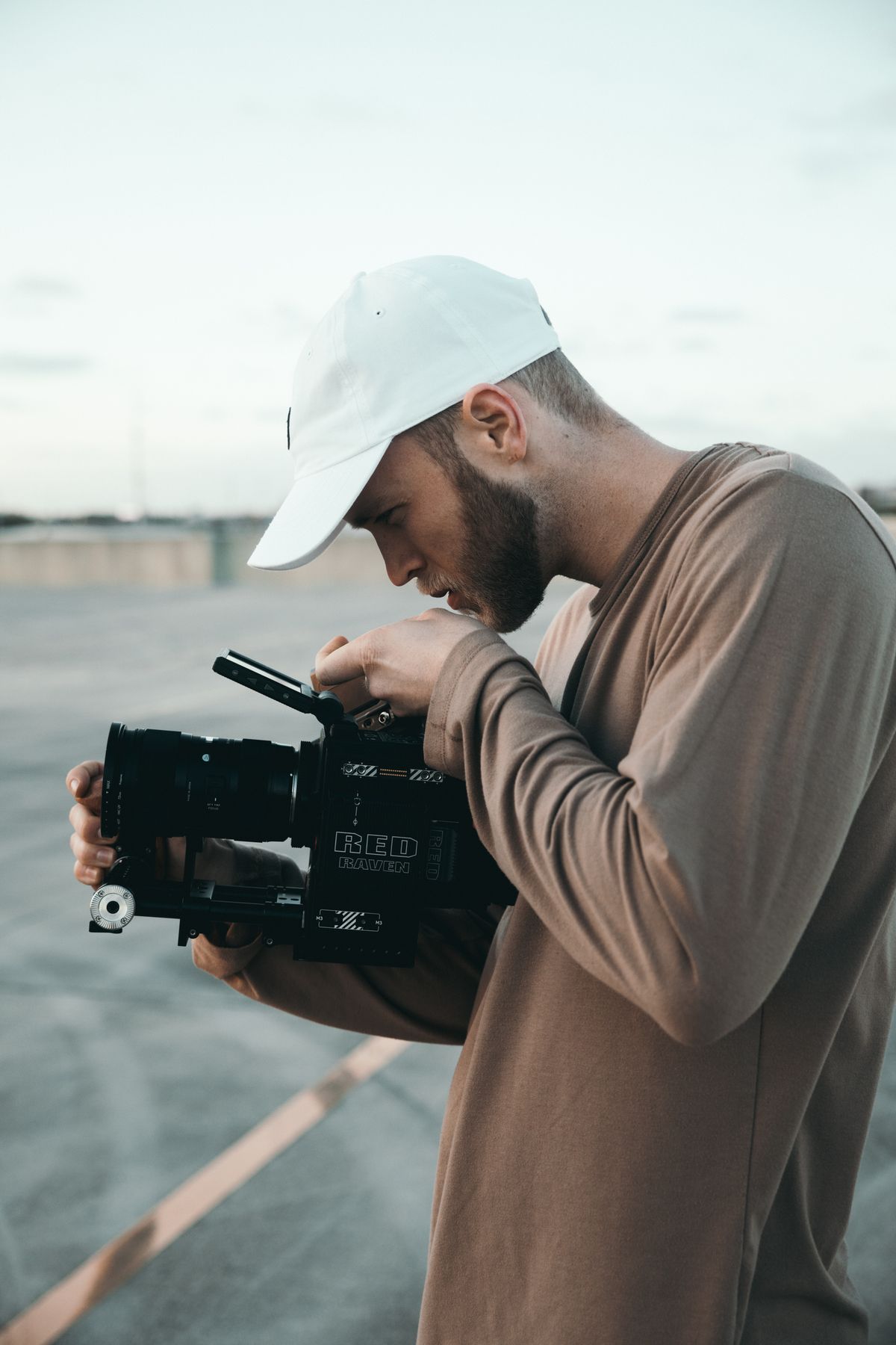 Cinematographer filming outdoors with professional camera gear